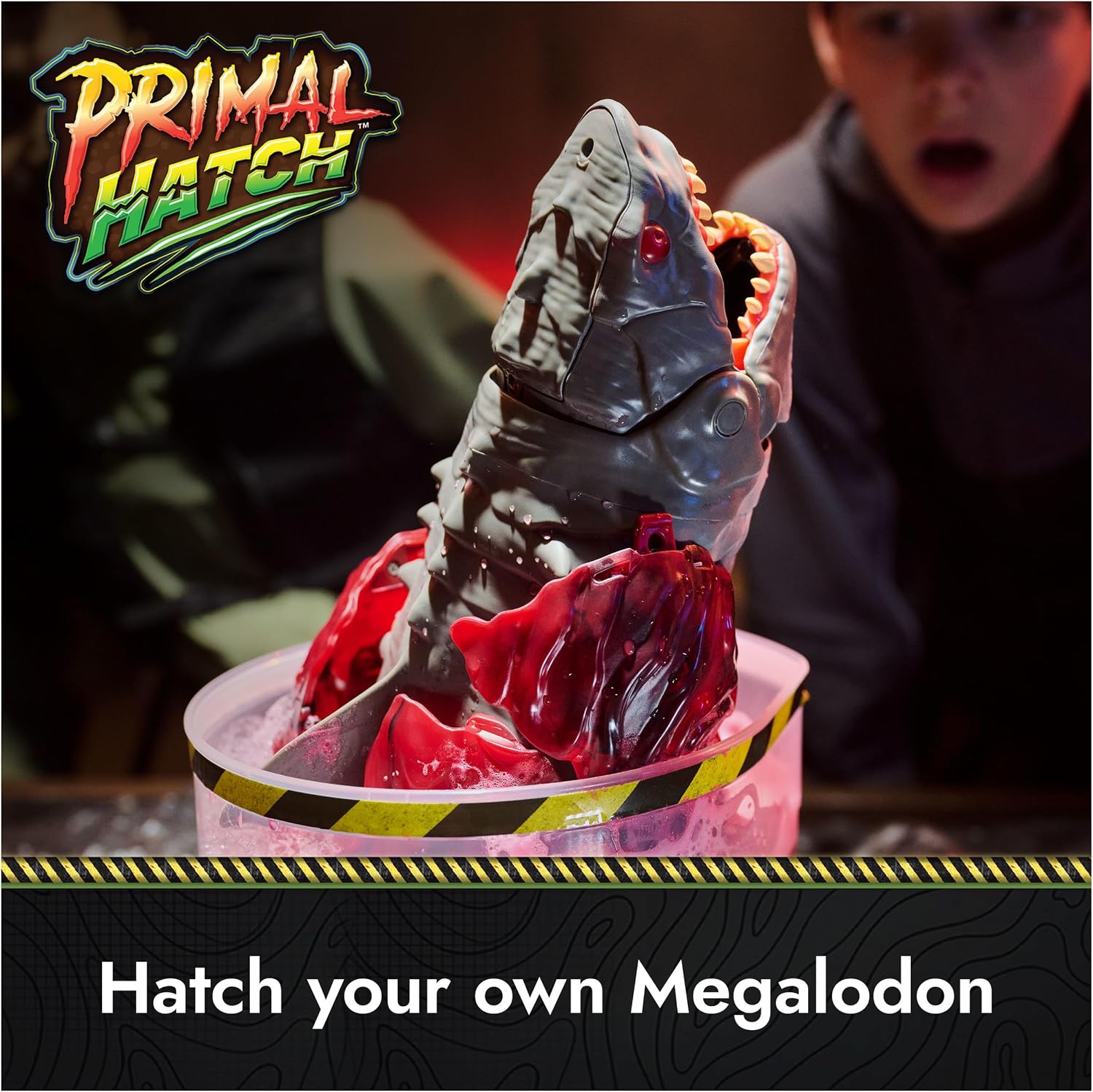 The Megalodon breaking out of the red fizzing goo inside its tank
