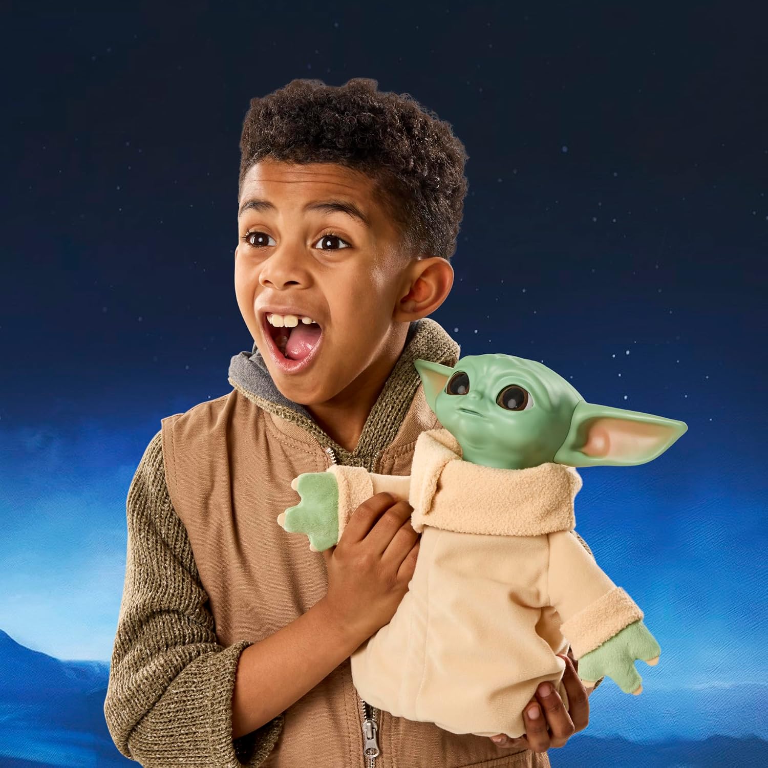 A child hugging the Star Wars Action Buddy Grogu animatronic plush