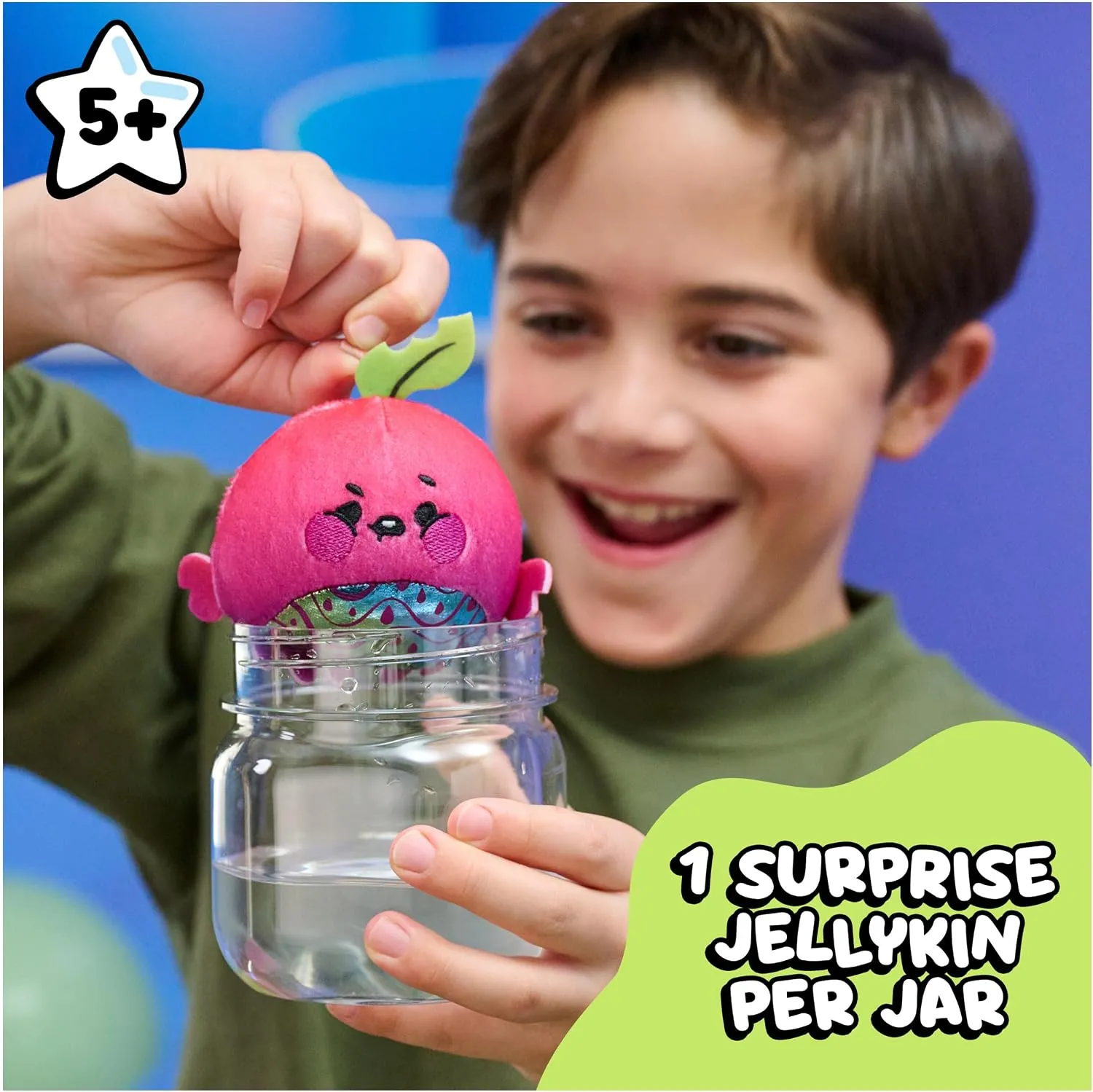 Child holding a Magic Jellykins jar with the plush revealed inside