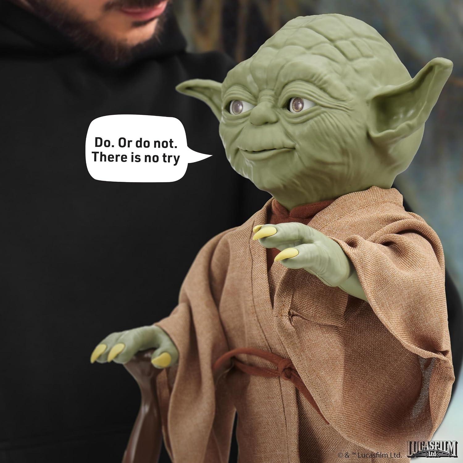 A person operating the Yoda Puppetronic, with the line Do. Or do not. There is no try