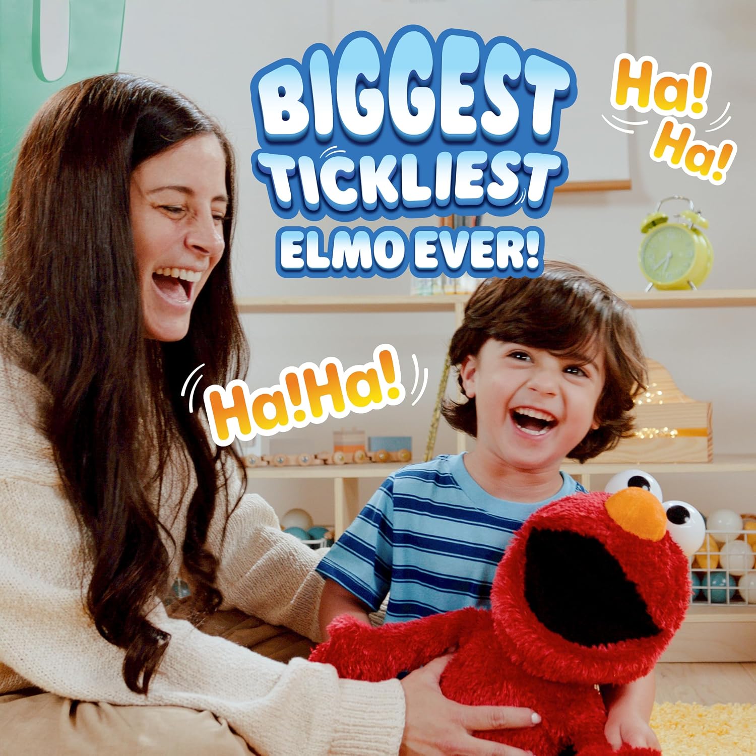 An adult and a child playing with the Tickle Me Elmo Giggle Max, showing its 18-inch size