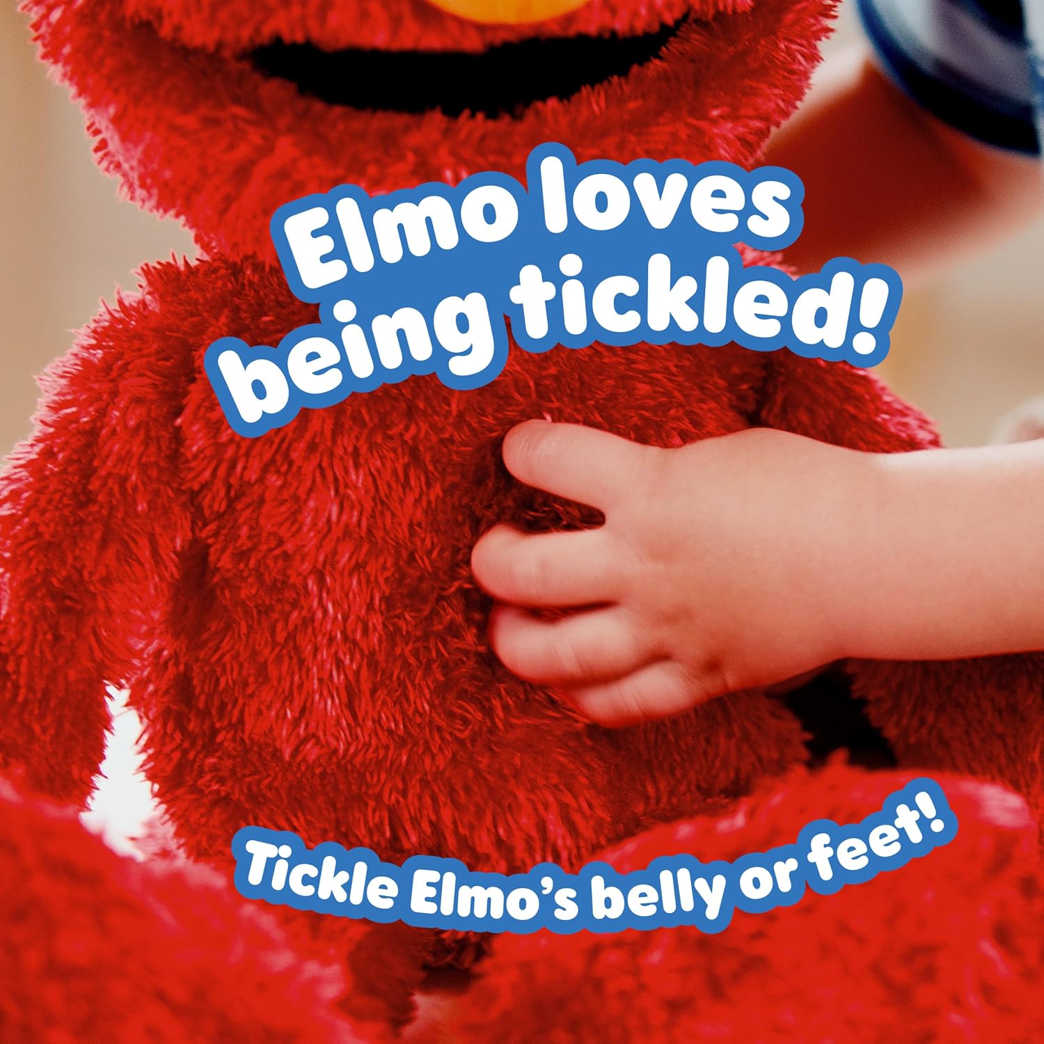 A child tickling the belly of the Tickle Me Elmo Giggle Max plush